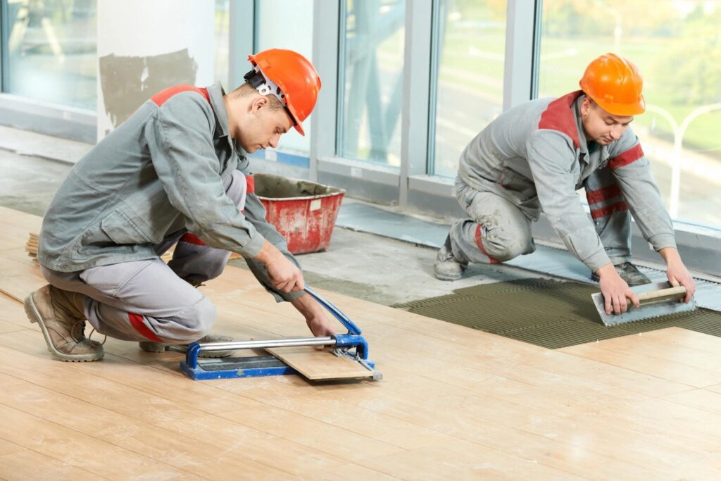 Technicians Installing Wood-Patterned Tile Flooring